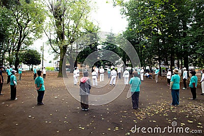 Asian elderly people practicing Tai Chi at public park Editorial Stock Photo